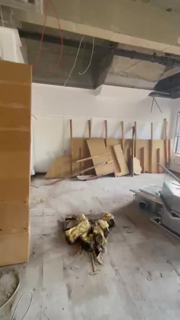 Removed doors and panels standing against a wall inside Halifax House during strip-out.