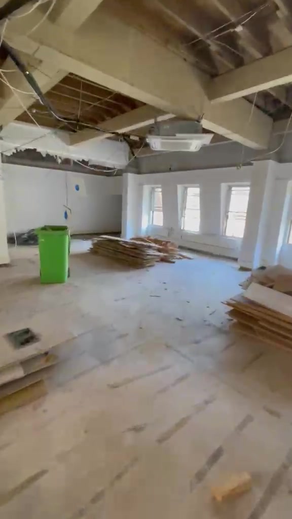 Timber stacked beside an area of removed flooring during the Halifax House strip-out.